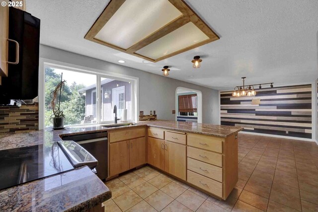 1168 Risden Pl, Eugene, OR 97404 - kitchen with light brown cabinets, dishwasher, a textured ceiling, a chandelier, and a peninsula