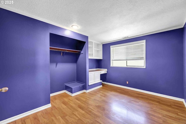 1168 Risden Pl, Eugene, OR 97404 - unfurnished bedroom featuring a textured ceiling, light wood-style floors, and a closet