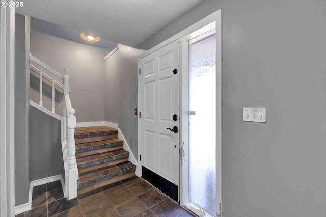 1168 Risden Pl, Eugene, OR 97404 - entrance foyer with stairs, a textured ceiling, and dark stone finish flooring