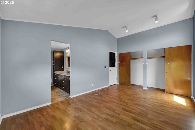 1168 Risden Pl, Eugene, OR 97404 - unfurnished bedroom featuring two closets, vaulted ceiling, wood finished floors, and ensuite bath