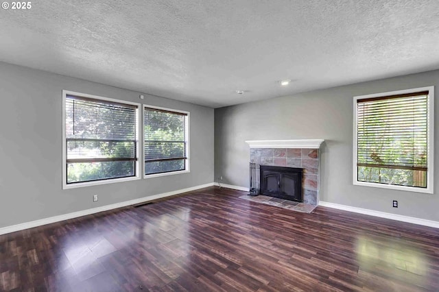 1168 Risden Pl, Eugene, OR 97404 - unfurnished living room with a textured ceiling, wood finished floors, and a tile fireplace