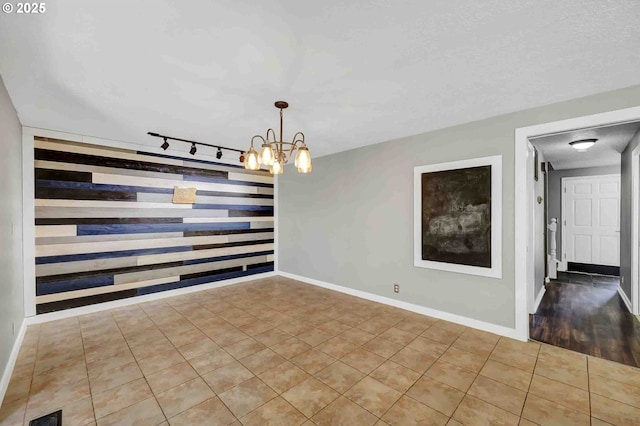 1168 Risden Pl, Eugene, OR 97404 - unfurnished room with rail lighting, tile patterned floors, and a chandelier