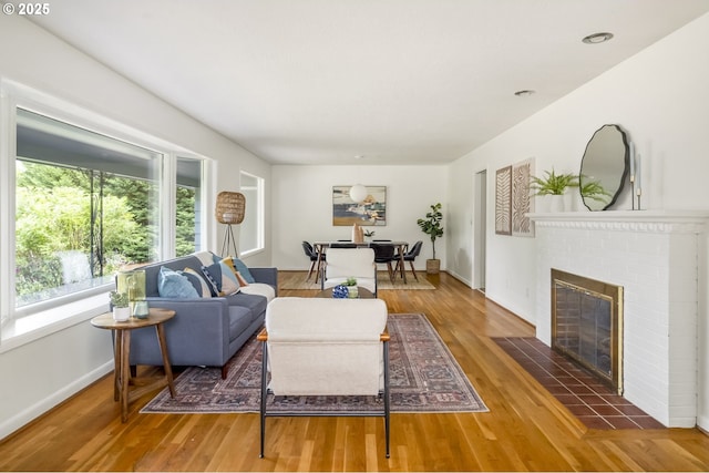1070 SW Portola Ave, Portland, OR 97225 - living room featuring a brick fireplace and wood finished floors