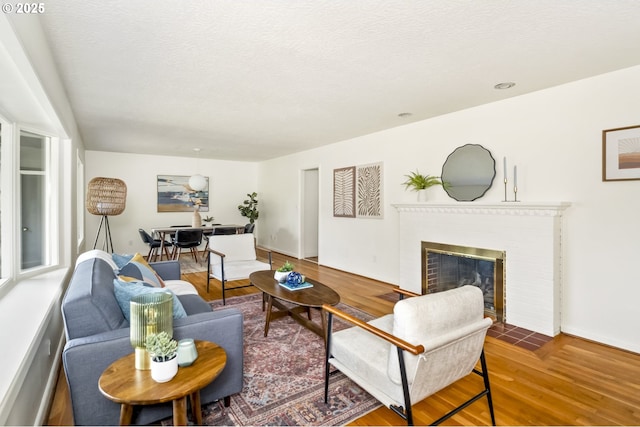 1070 SW Portola Ave, Portland, OR 97225 - living area featuring wood finished floors and a brick fireplace
