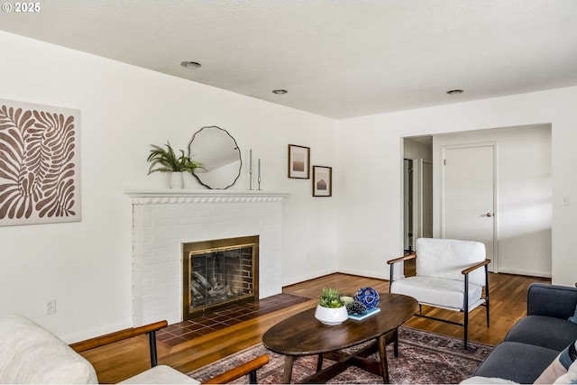 1070 SW Portola Ave, Portland, OR 97225 - living area featuring wood finished floors and a brick fireplace