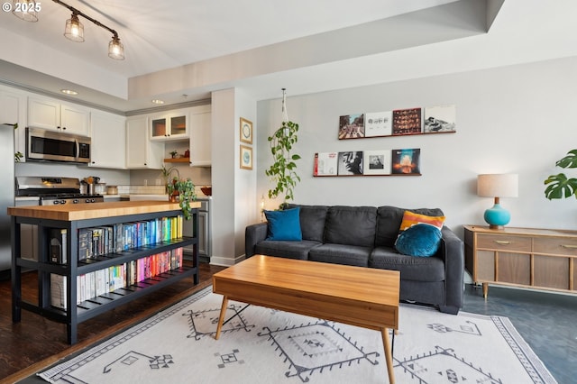 living room featuring baseboards and recessed lighting