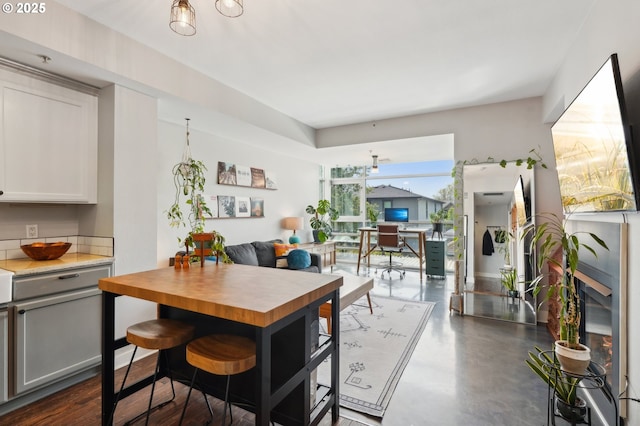dining space featuring concrete floors