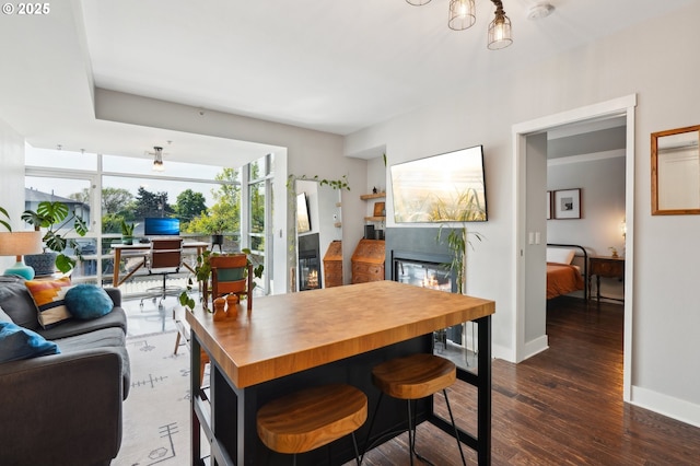 dining space with baseboards and hardwood / wood-style flooring