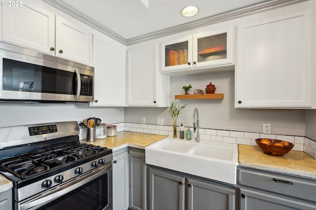 kitchen with a sink, appliances with stainless steel finishes, and gray cabinets