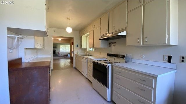 kitchen with white appliances, light countertops, under cabinet range hood, a sink, and concrete floors