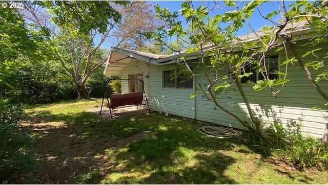 view of property exterior with a lawn