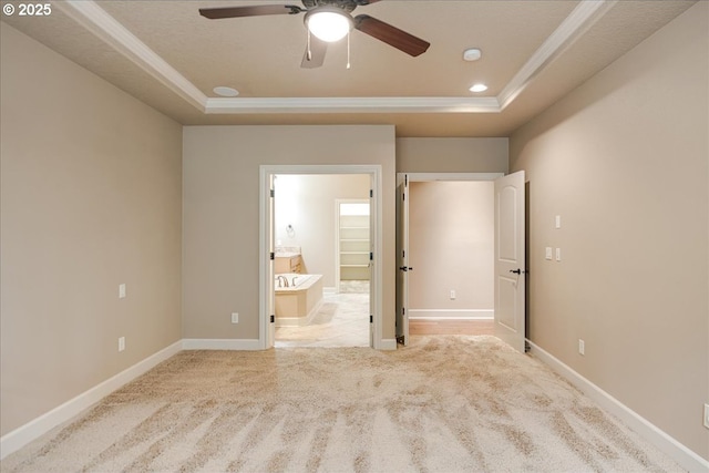 unfurnished bedroom featuring baseboards, carpet, and a tray ceiling