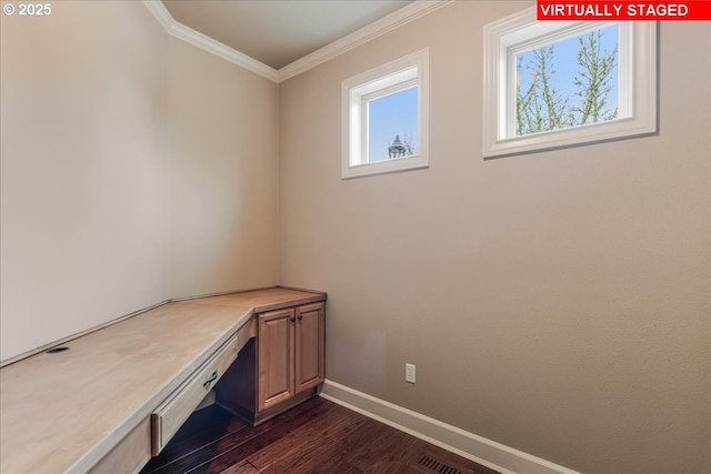 unfurnished office featuring ornamental molding, built in study area, baseboards, and dark wood-style flooring