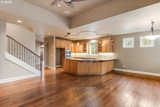 kitchen featuring baseboards, decorative backsplash, a peninsula, dark wood-style floors, and open shelves