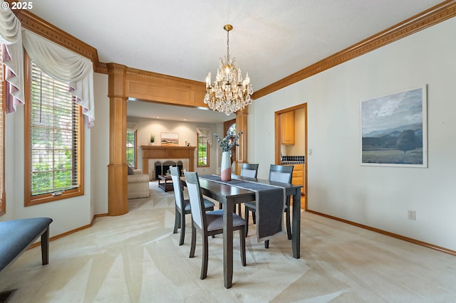 5844 Ridgetop Ct, Lake Oswego, OR 97035 - dining space with light carpet, a chandelier, ornamental molding, and a fireplace