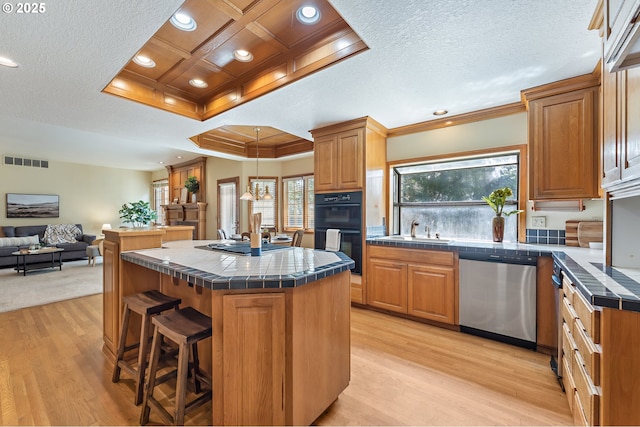5844 Ridgetop Ct, Lake Oswego, OR 97035 - kitchen featuring dishwasher, ornamental molding, tile counters, a center island, and light wood-style floors