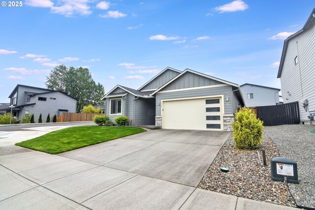 5009 NE 85th St, Vancouver, WA 98665 - view of front facade featuring board and batten siding, fence, a garage, stone siding, and concrete driveway