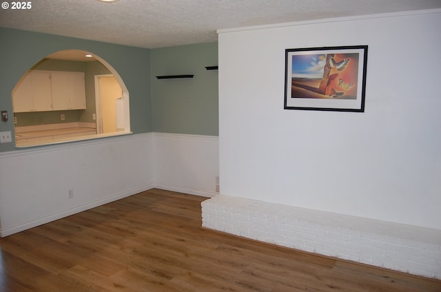 3024 Concord Way, Forest Grove, OR 97116 - spare room featuring wood finished floors, a textured ceiling, and arched walkways