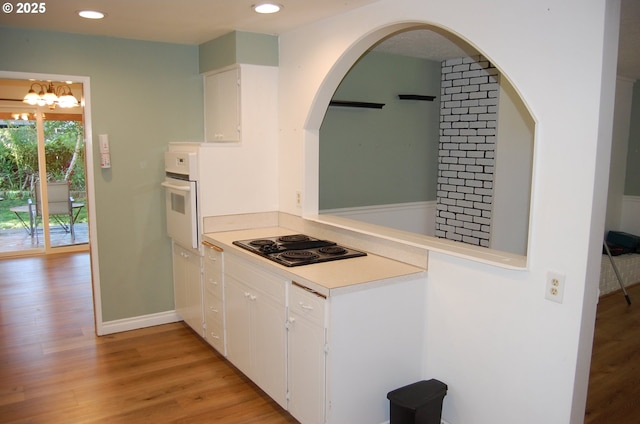 3024 Concord Way, Forest Grove, OR 97116 - kitchen featuring white oven, black electric stovetop, light wood finished floors, white cabinets, and recessed lighting