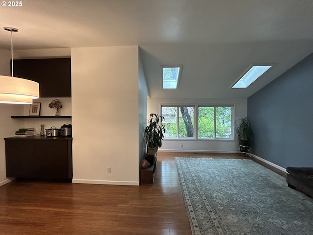 4768 Manzanita St, Eugene, OR 97405 - unfurnished living room with a skylight, baseboards, dark wood-style floors, and vaulted ceiling