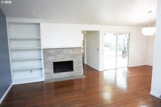 4768 Manzanita St, Eugene, OR 97405 - unfurnished living room with baseboards, wood finished floors, a tile fireplace, and built in shelves