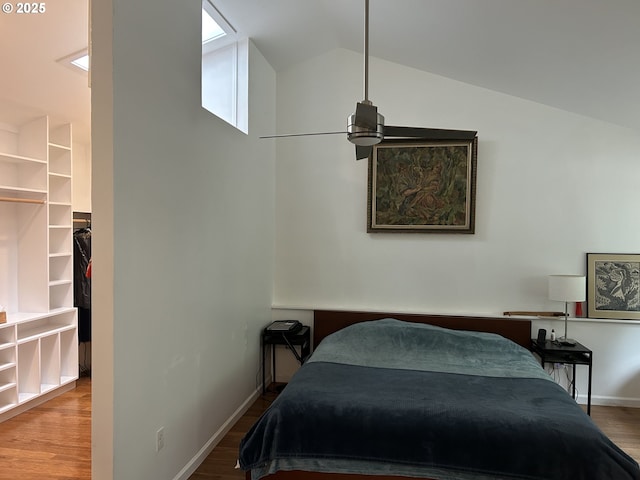 4768 Manzanita St, Eugene, OR 97405 - bedroom with wood finished floors, vaulted ceiling, a walk in closet, and baseboards