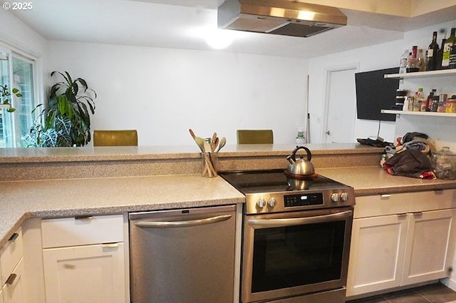 4768 Manzanita St, Eugene, OR 97405 - kitchen featuring appliances with stainless steel finishes, ventilation hood, light countertops, open shelves, and white cabinets