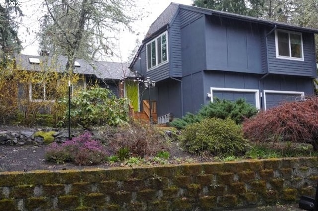 4768 Manzanita St, Eugene, OR 97405 - view of side of home with an attached garage and board and batten siding