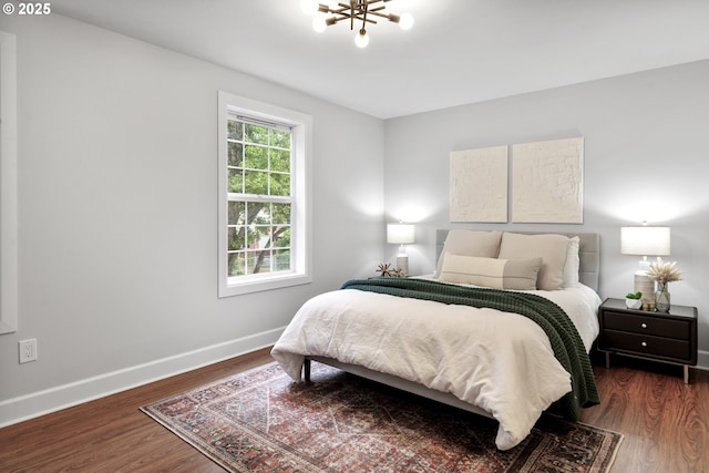 bedroom with baseboards and dark wood-style floors
