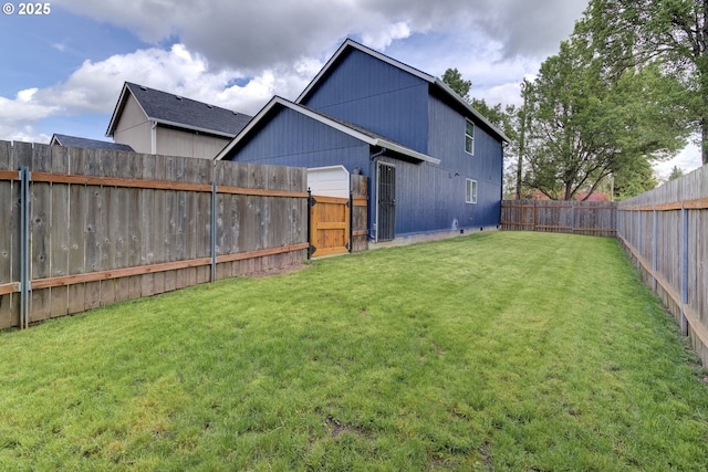 view of yard featuring a fenced backyard and a gate