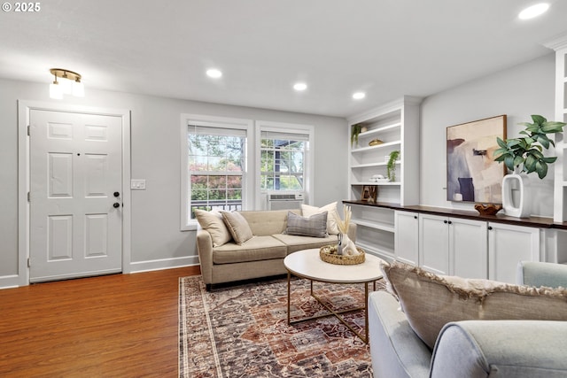 living area with recessed lighting, baseboards, and wood finished floors