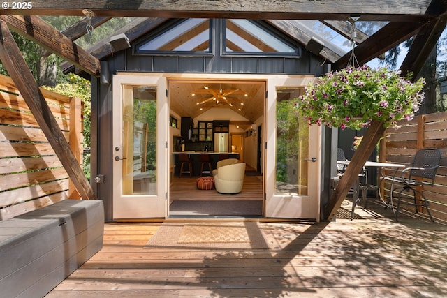 wooden terrace featuring an outbuilding and fence