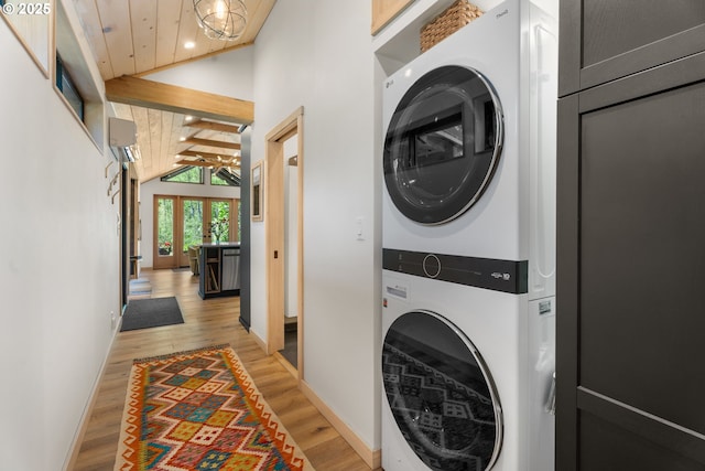 laundry area with stacked washer and clothes dryer, light wood-type flooring, baseboards, recessed lighting, and wooden ceiling