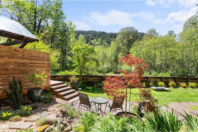 view of yard with a forest view