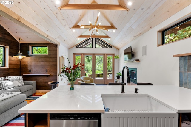 kitchen featuring open floor plan, a sink, french doors, dishwasher, and wooden ceiling