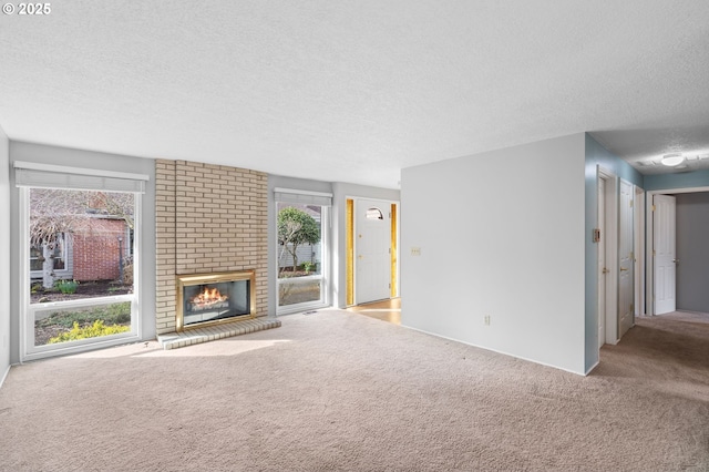 5016 SW Normandy Pl, Beaverton, OR 97005 - unfurnished living room with carpet, a textured ceiling, and a brick fireplace