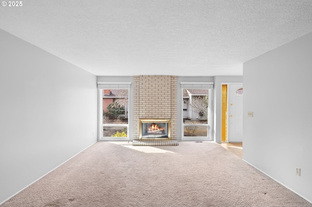 5016 SW Normandy Pl, Beaverton, OR 97005 - unfurnished living room with carpet flooring, a fireplace, and a textured ceiling