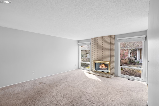 5016 SW Normandy Pl, Beaverton, OR 97005 - unfurnished living room with a brick fireplace, carpet floors, a textured ceiling, and baseboards