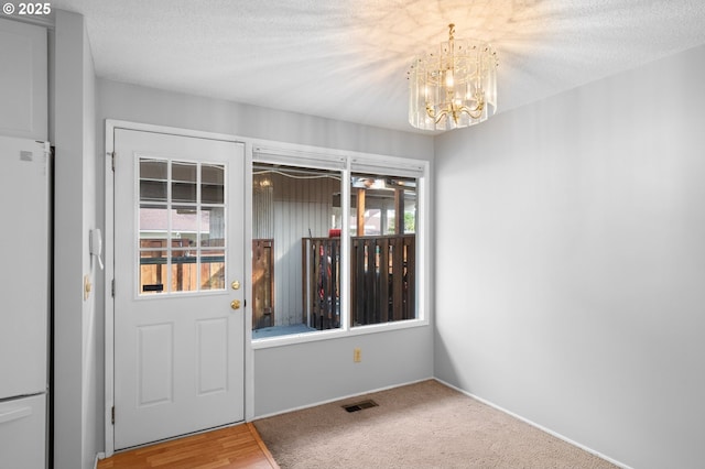 5016 SW Normandy Pl, Beaverton, OR 97005 - interior space featuring a chandelier, baseboards, carpet, and a textured ceiling