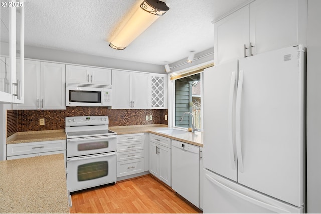 5016 SW Normandy Pl, Beaverton, OR 97005 - kitchen featuring white appliances, a sink, light countertops, white cabinets, and a textured ceiling