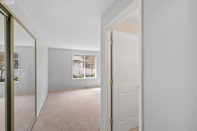 5016 SW Normandy Pl, Beaverton, OR 97005 - corridor featuring light colored carpet, a textured ceiling, and baseboards