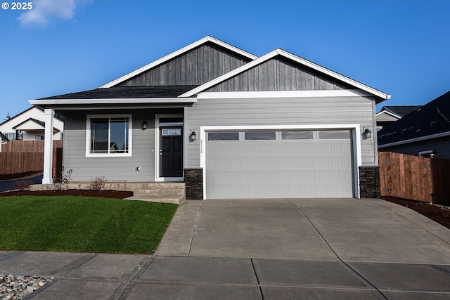 view of front of property featuring a garage and a front yard