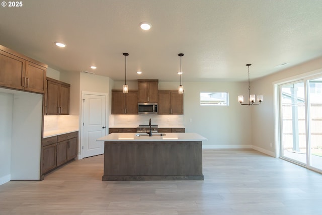 kitchen with backsplash, dark wood-style flooring, appliances with stainless steel finishes, and a sink