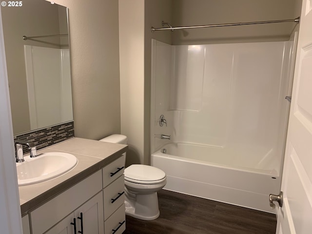 full bathroom featuring hardwood / wood-style flooring, vanity, decorative backsplash, shower / bathtub combination, and toilet