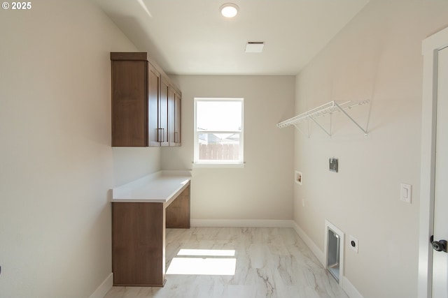 clothes washing area with electric dryer hookup, washer hookup, marble finish floor, and baseboards
