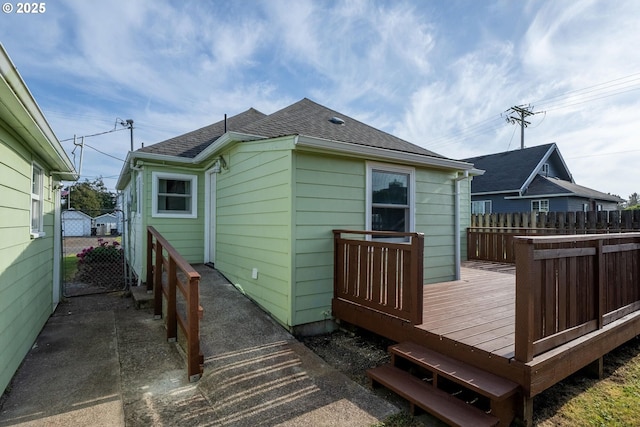 1108 4th St, Tillamook, OR 97141 - rear view of property with a deck, roof with shingles, and a gate