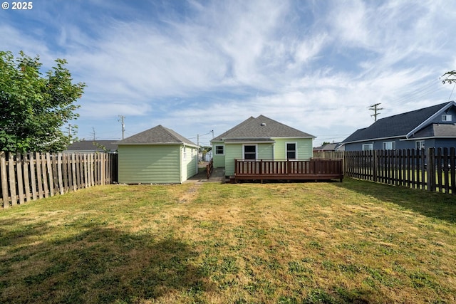 1108 4th St, Tillamook, OR 97141 - back of house with a fenced backyard, a deck, and an outdoor structure