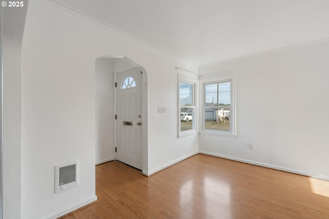 1108 4th St, Tillamook, OR 97141 - foyer with arched walkways, wood finished floors, ornamental molding, and heating unit
