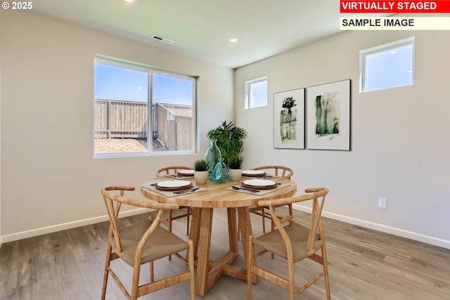dining space featuring recessed lighting, visible vents, baseboards, and wood finished floors