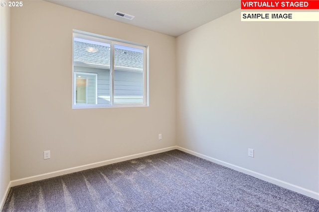 spare room with dark carpet, baseboards, and visible vents